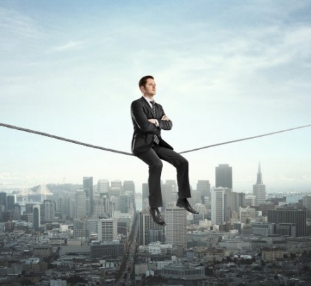 businessman sitting on rope and city